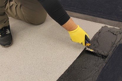 Close up of a contractor applying Liberty Flashing Cement.